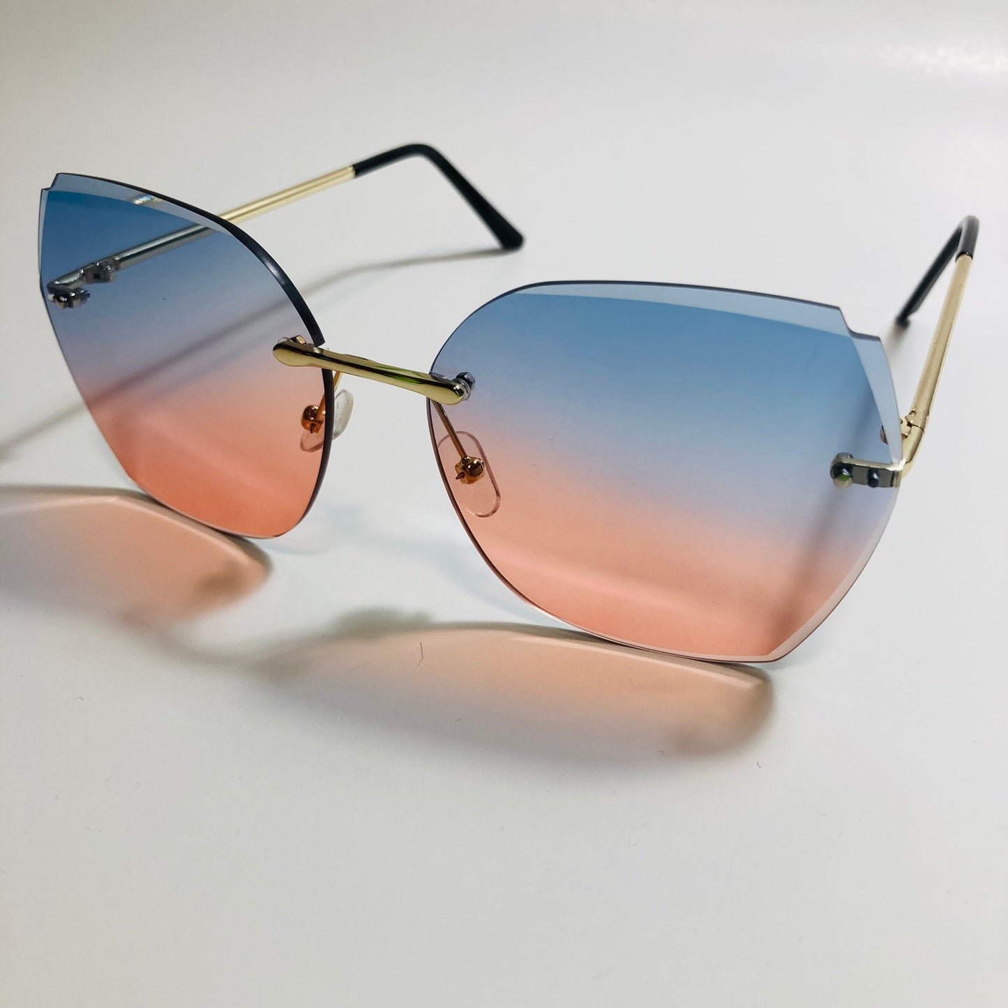 womens pink and blue oversize rimless sunglasses
