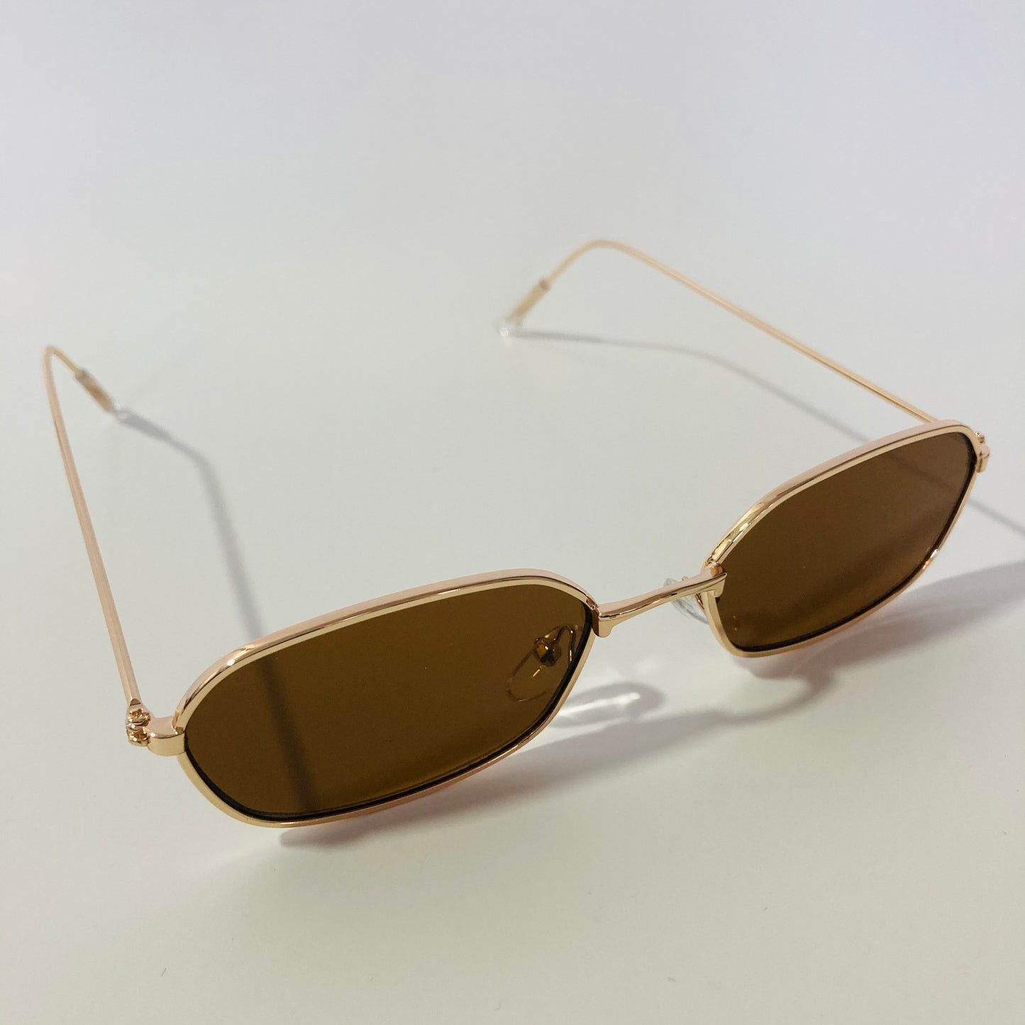 mens and womens brown and gold oval sunglasses