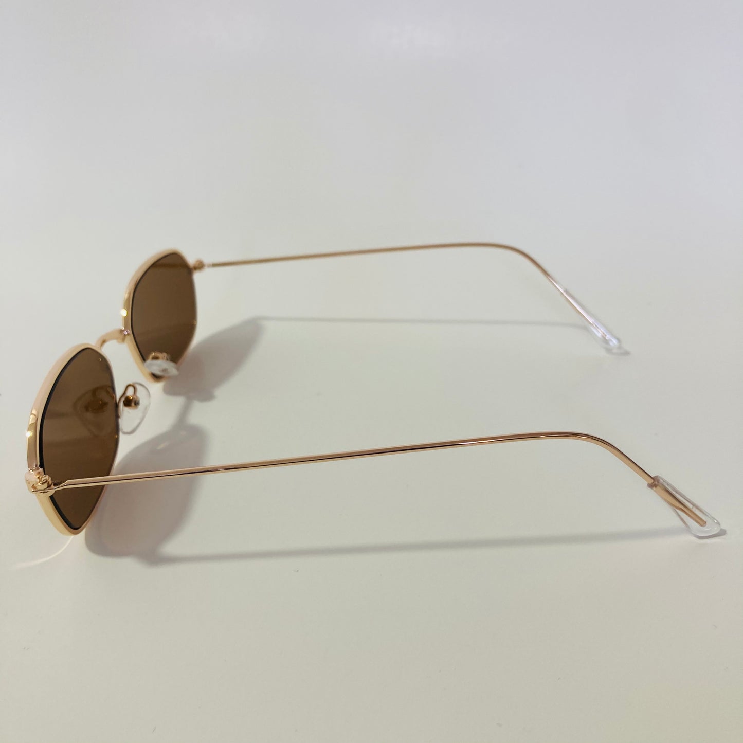 mens and womens brown and gold oval sunglasses