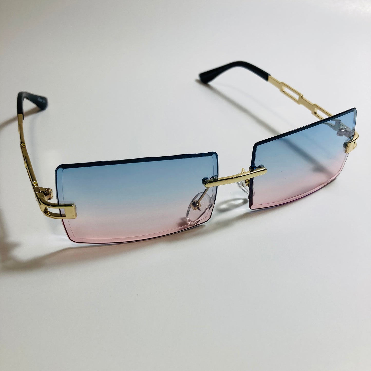 mens and womens pink blue and gold rimless square sunglasses