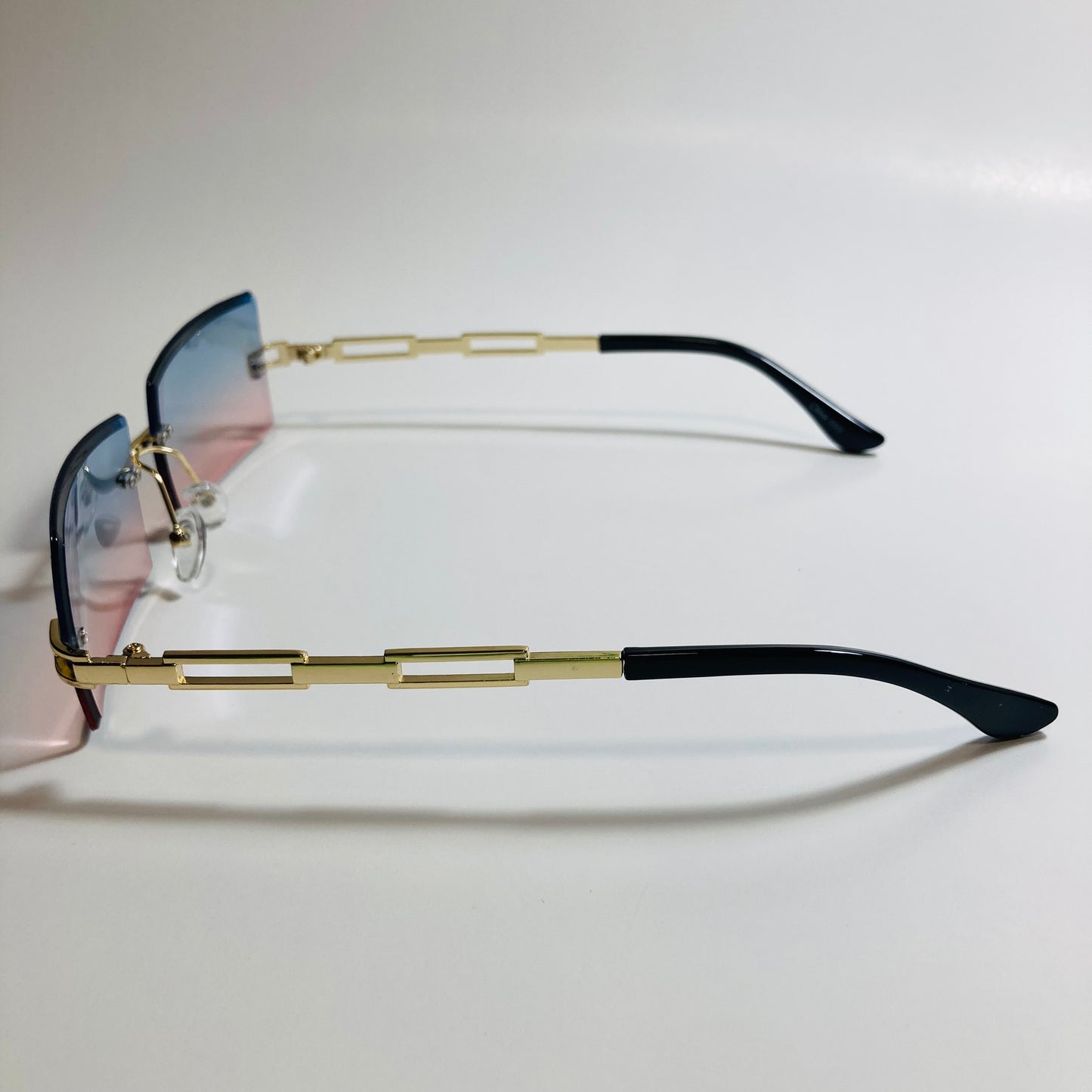 mens and womens pink blue and gold rimless square sunglasses