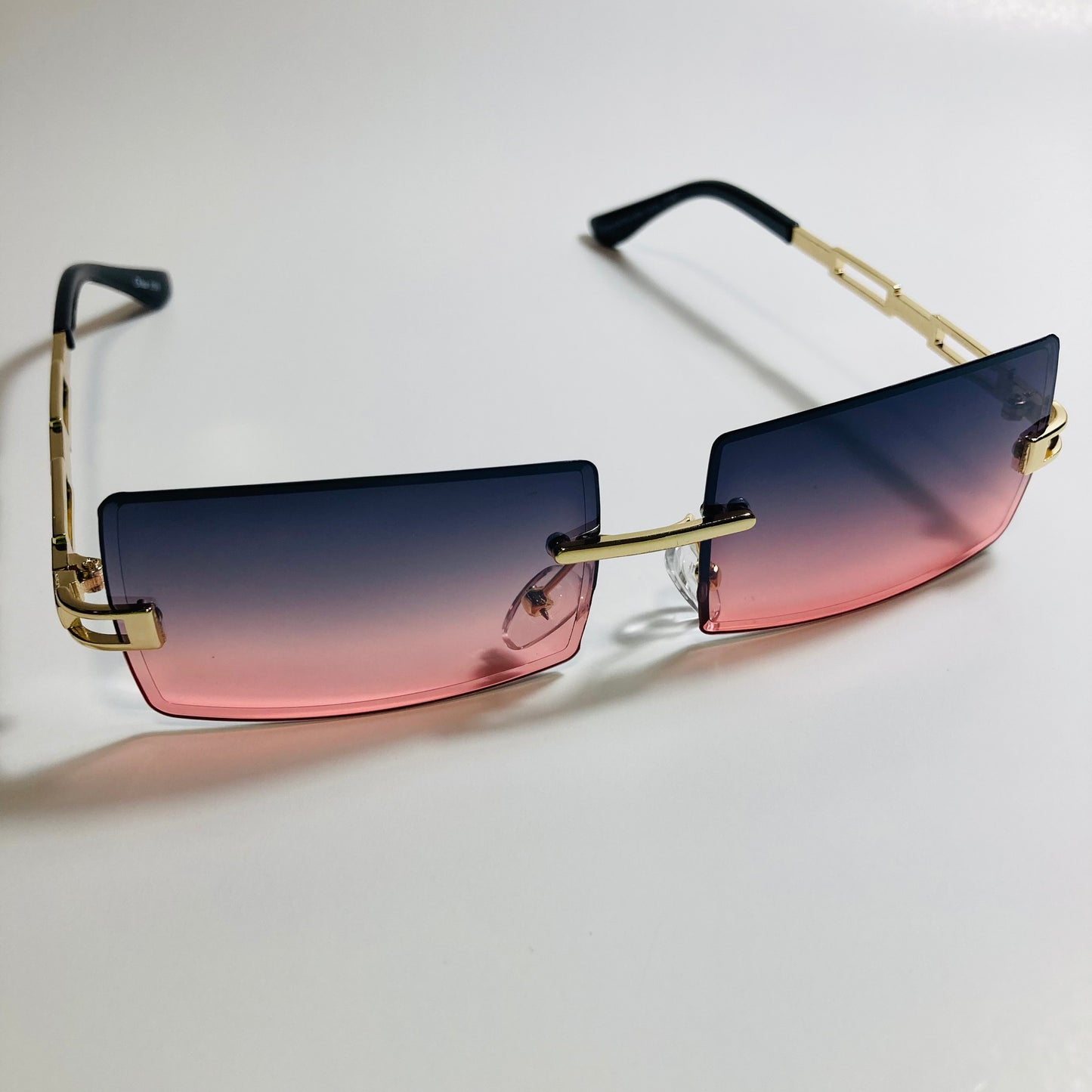mens and womens pink black and gold rimless square sunglasses