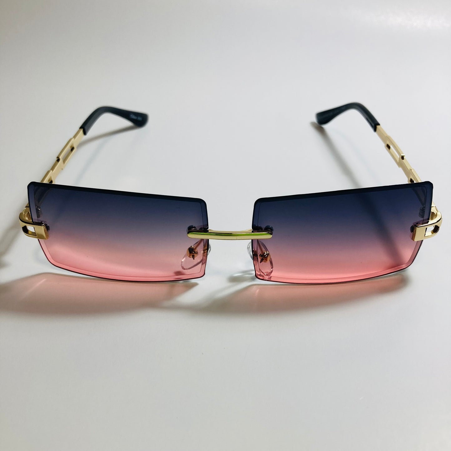 mens and womens pink black and gold rimless square sunglasses