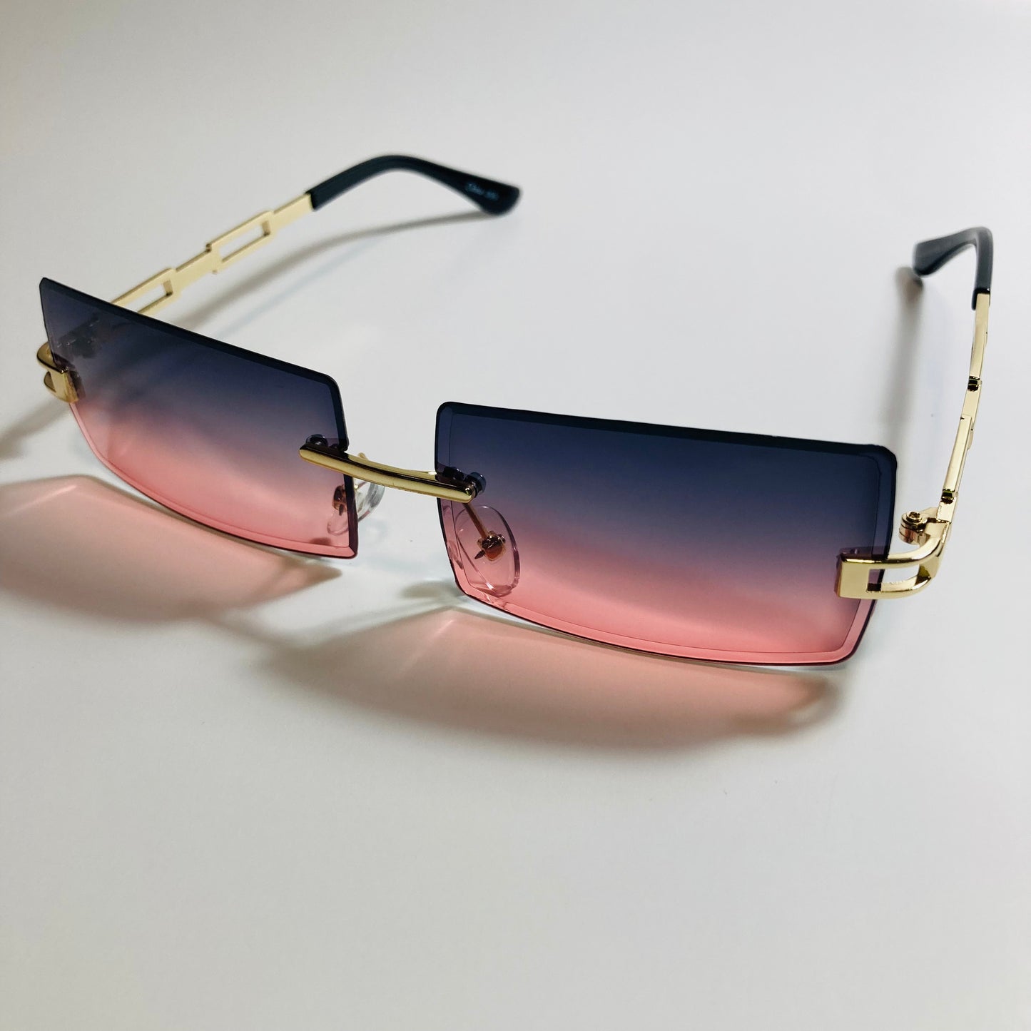 mens and womens pink black and gold rimless square sunglasses