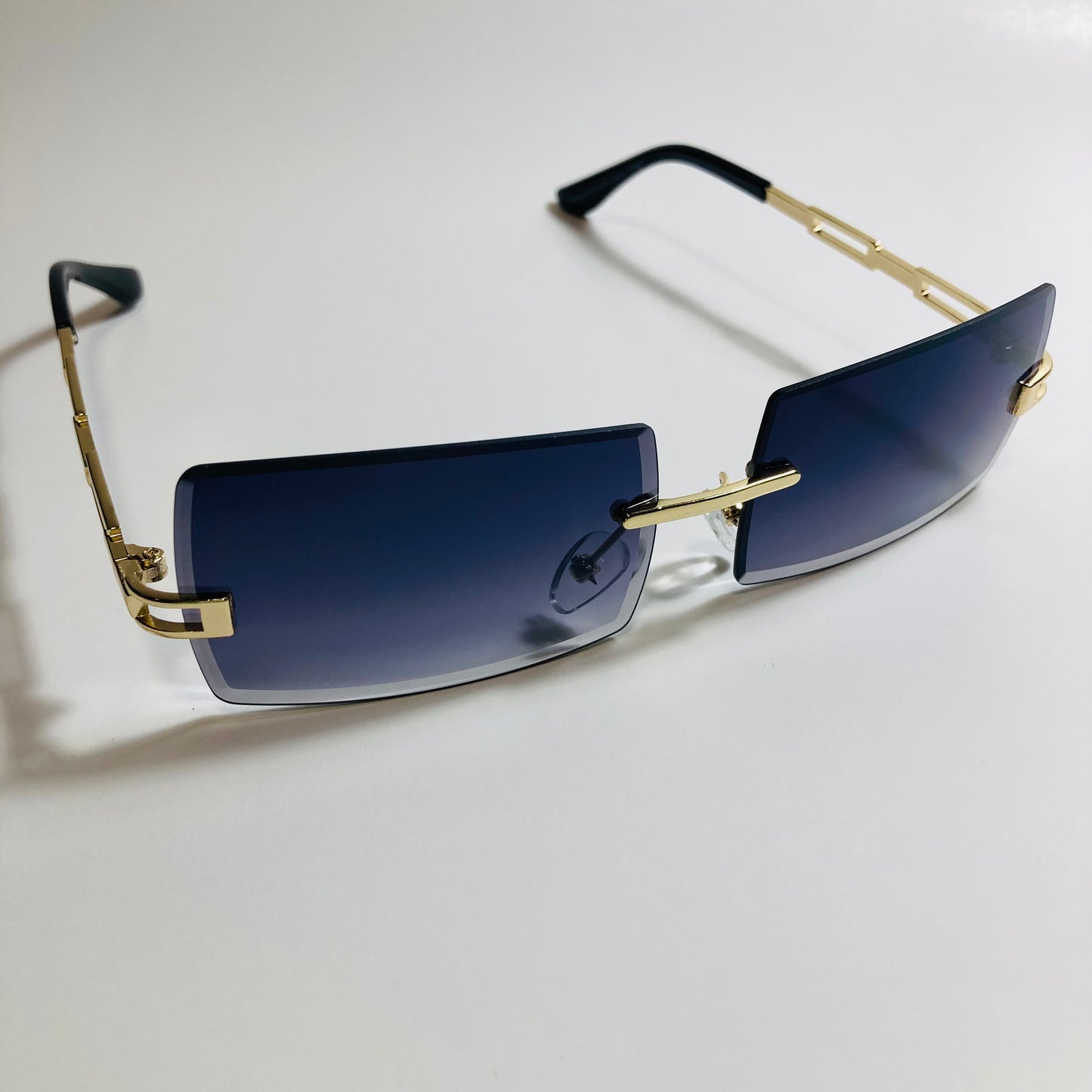 mens and womens black and gold rimless square sunglasses