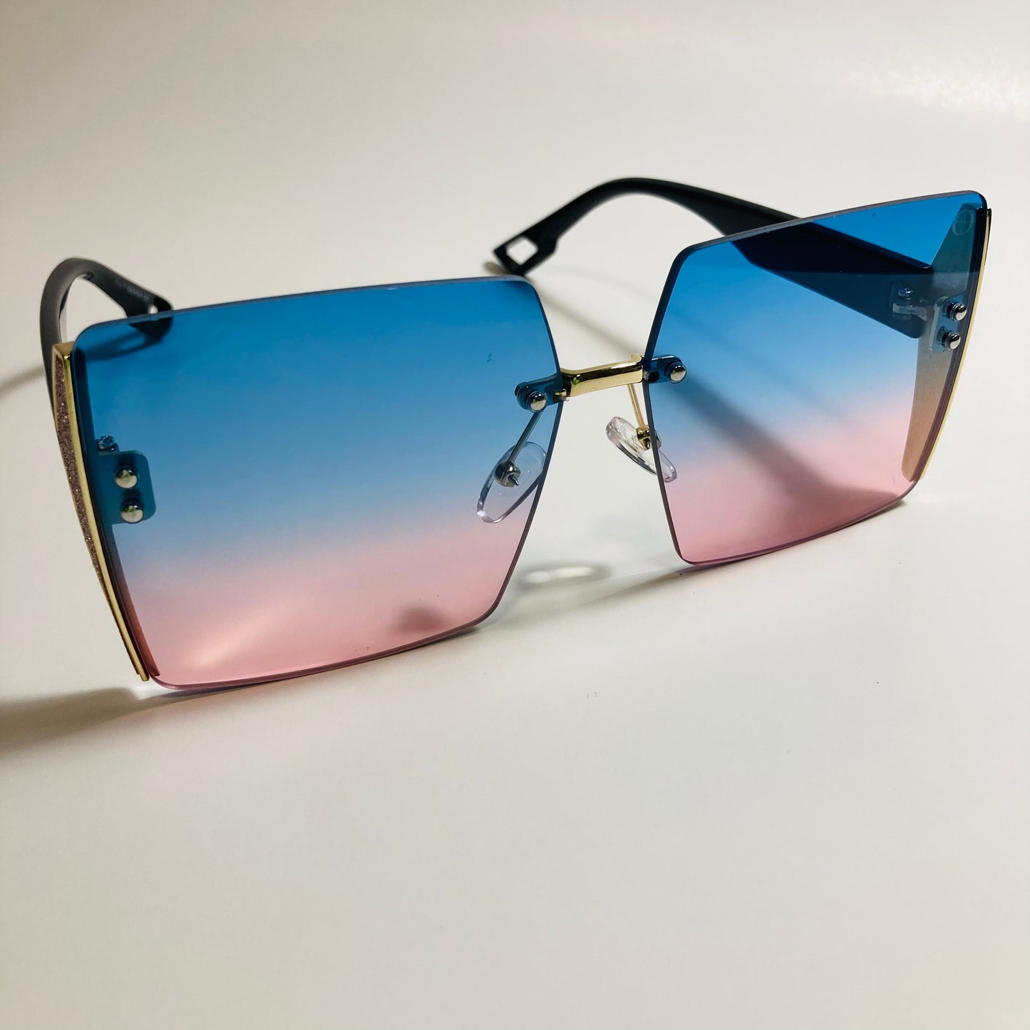 womens blue pink and gold rimless oversize square sunglasses
