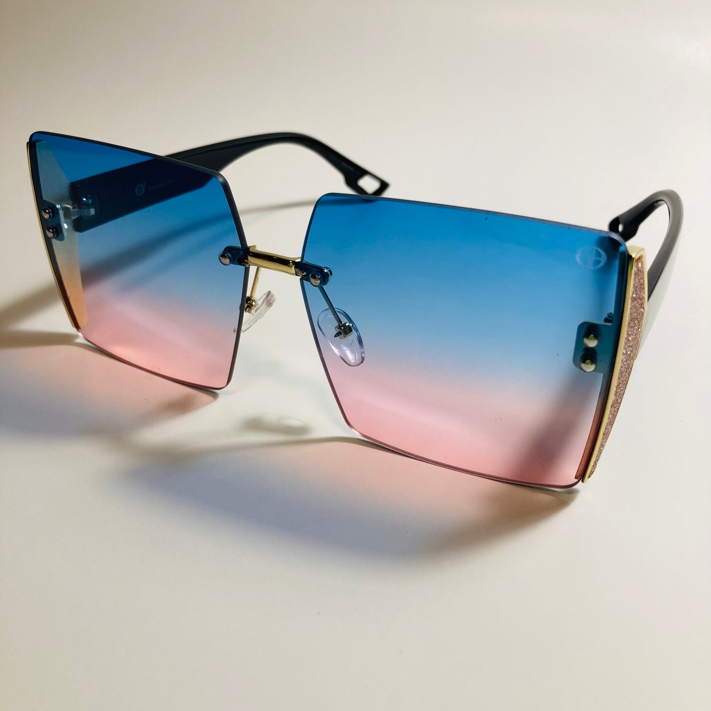 womens blue pink and gold rimless oversize square sunglasses