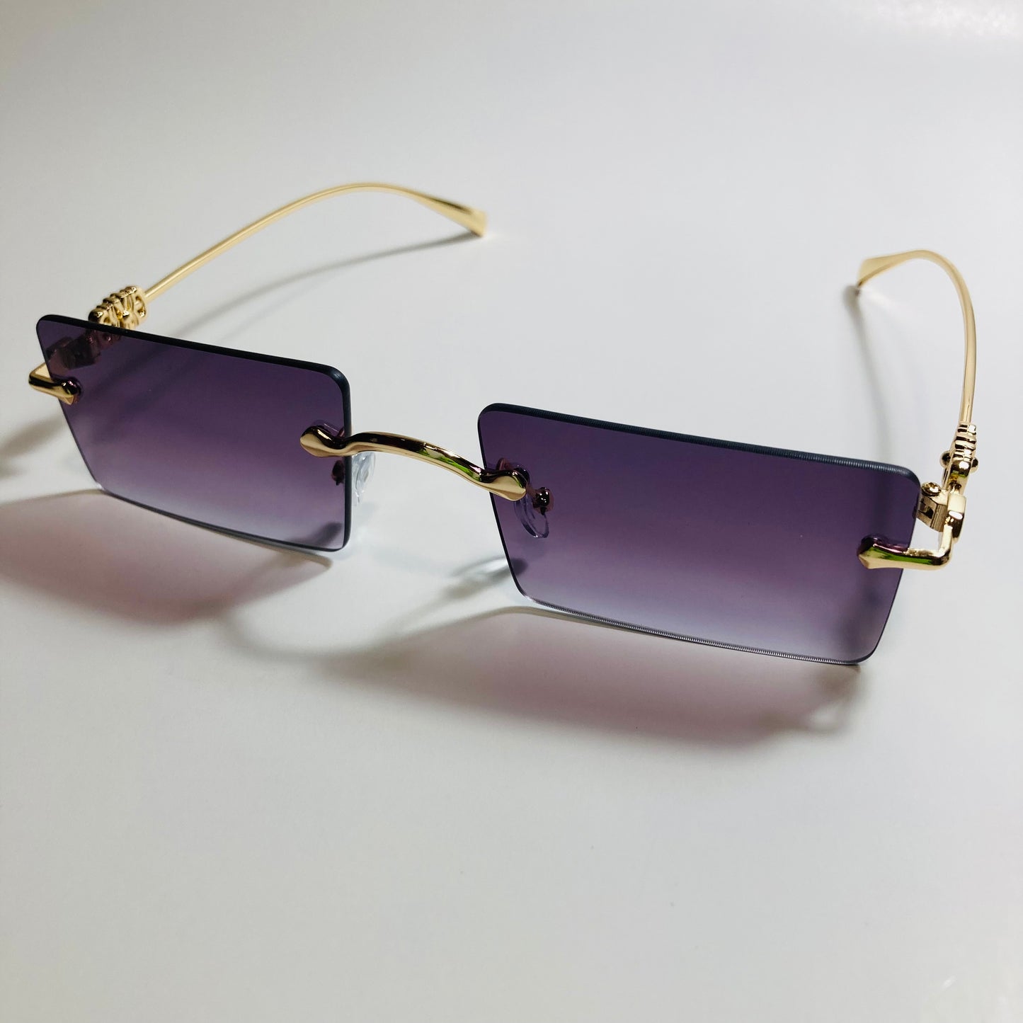 gold rimless womens sunglasses with black lenses and flower accent