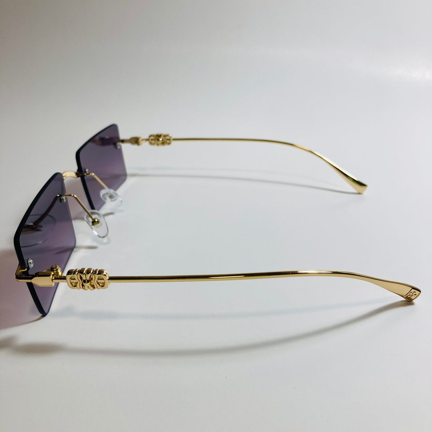 gold rimless womens sunglasses with black lenses and flower accent