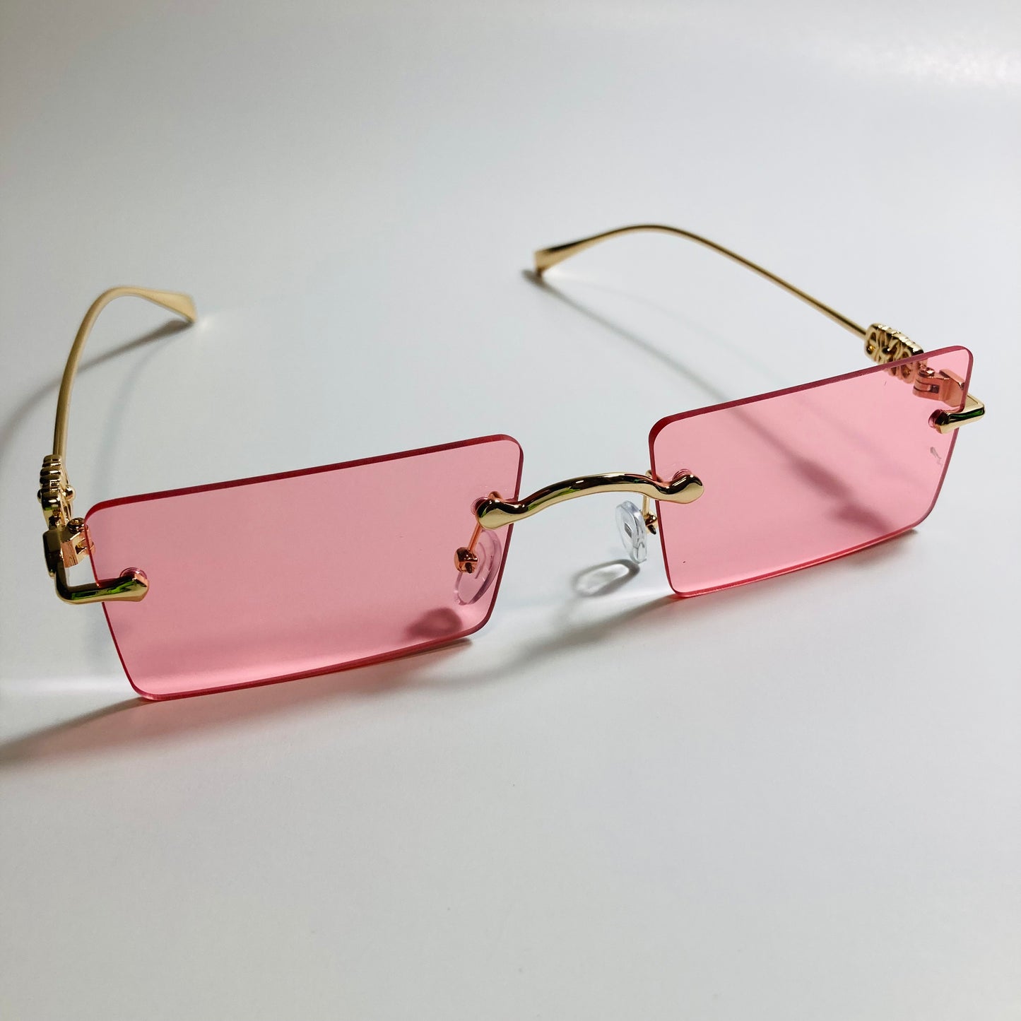 gold rimless womens sunglasses with pink lenses and flower accent