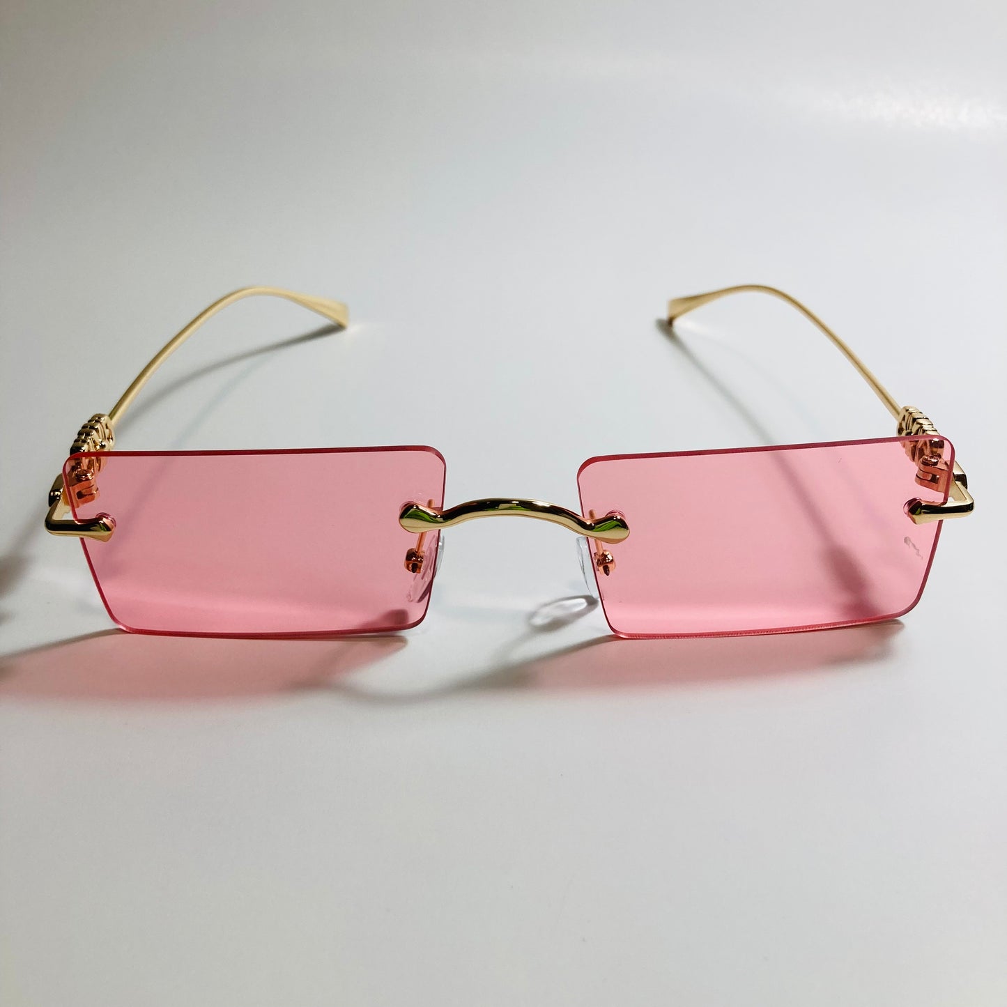 gold rimless womens sunglasses with pink lenses and flower accent