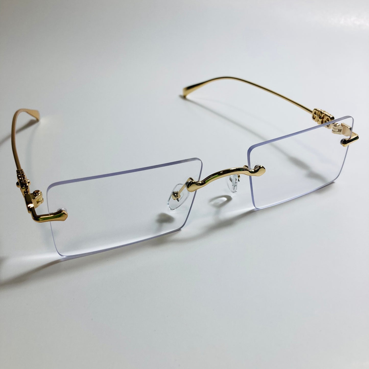 gold rimless womens sunglasses with clear lenses and flower accent