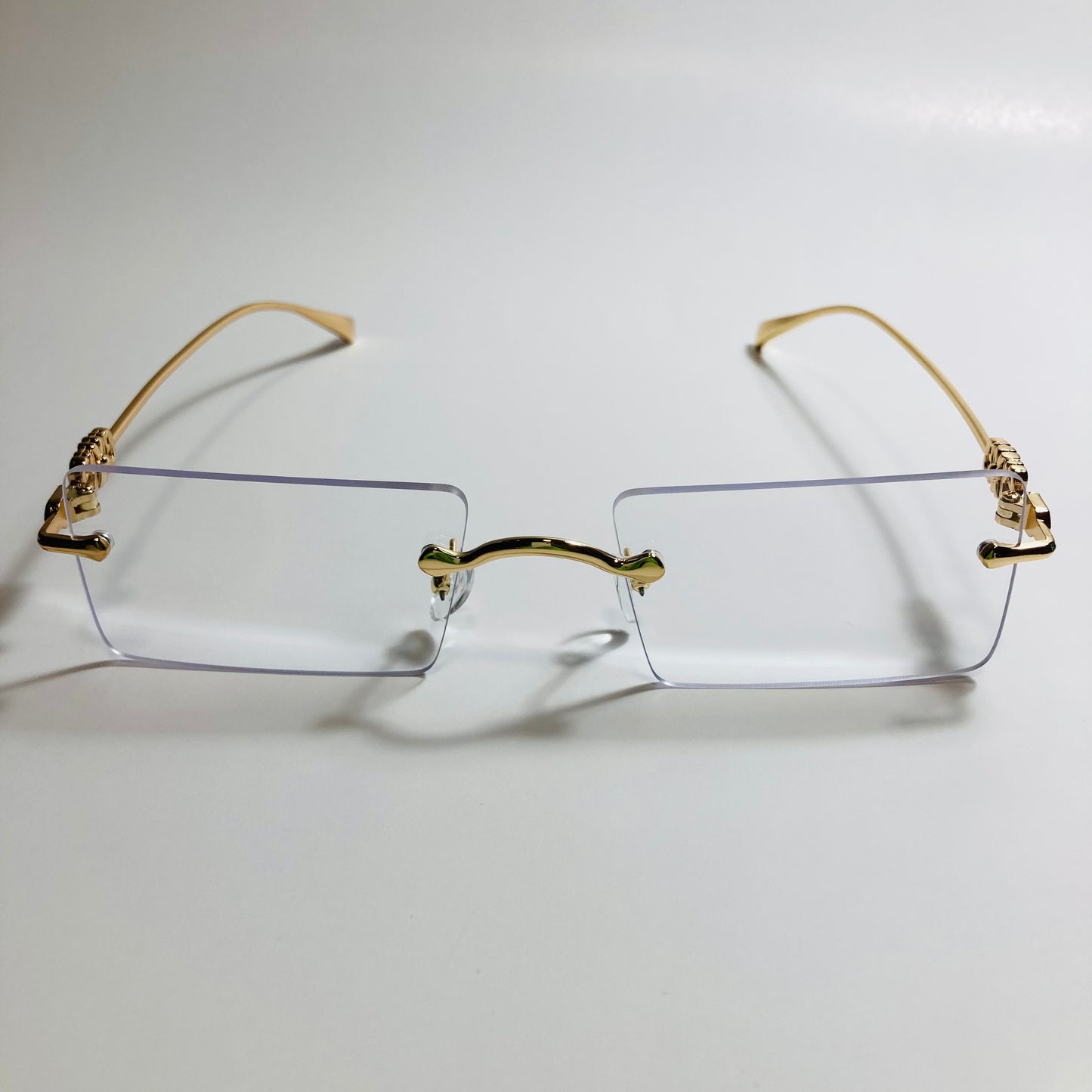 gold rimless womens sunglasses with clear lenses and flower accent