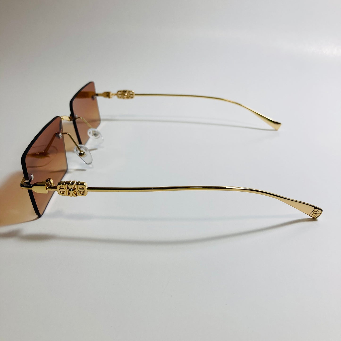 gold rimless womens sunglasses with brown lenses and flower accent