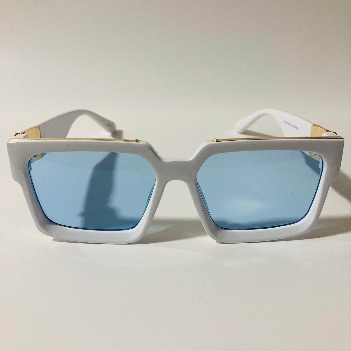 mens and womens white and blue square sunglasses with gold accents