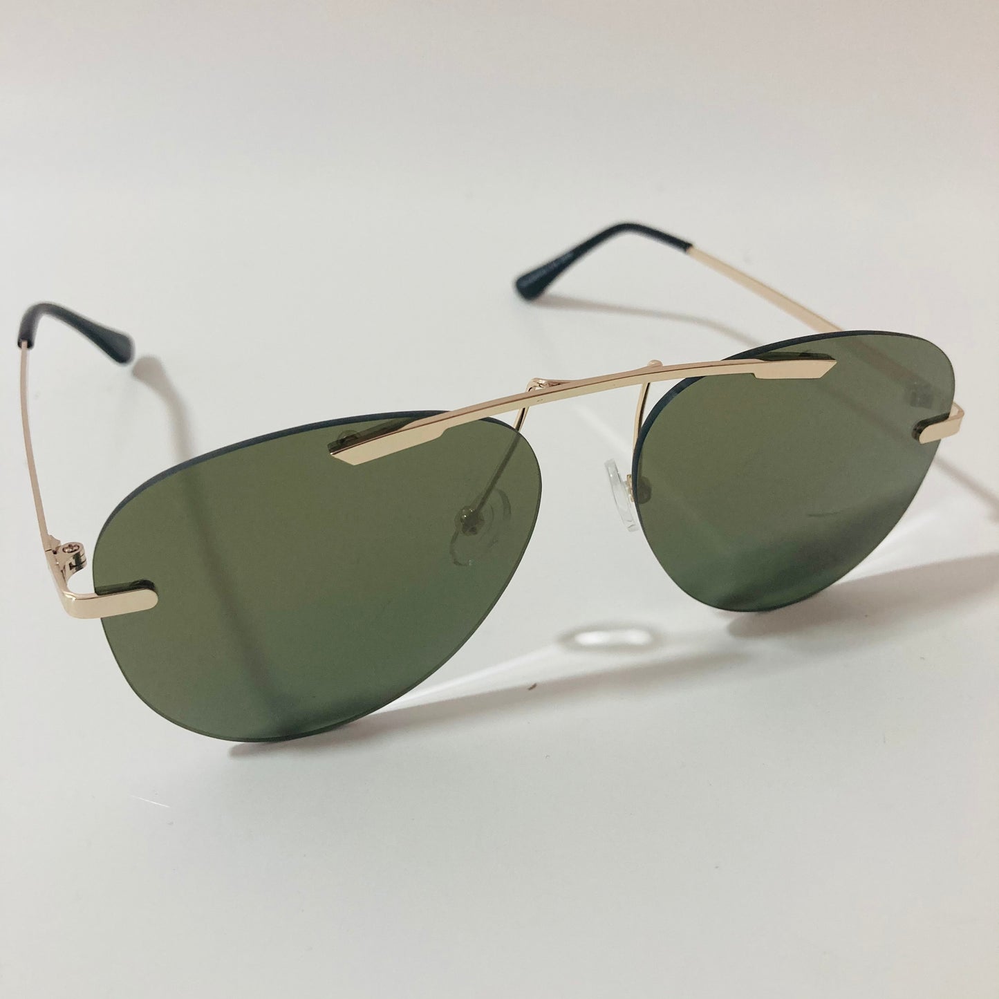 gold rimless aviator sunglasses with green mirror lenses