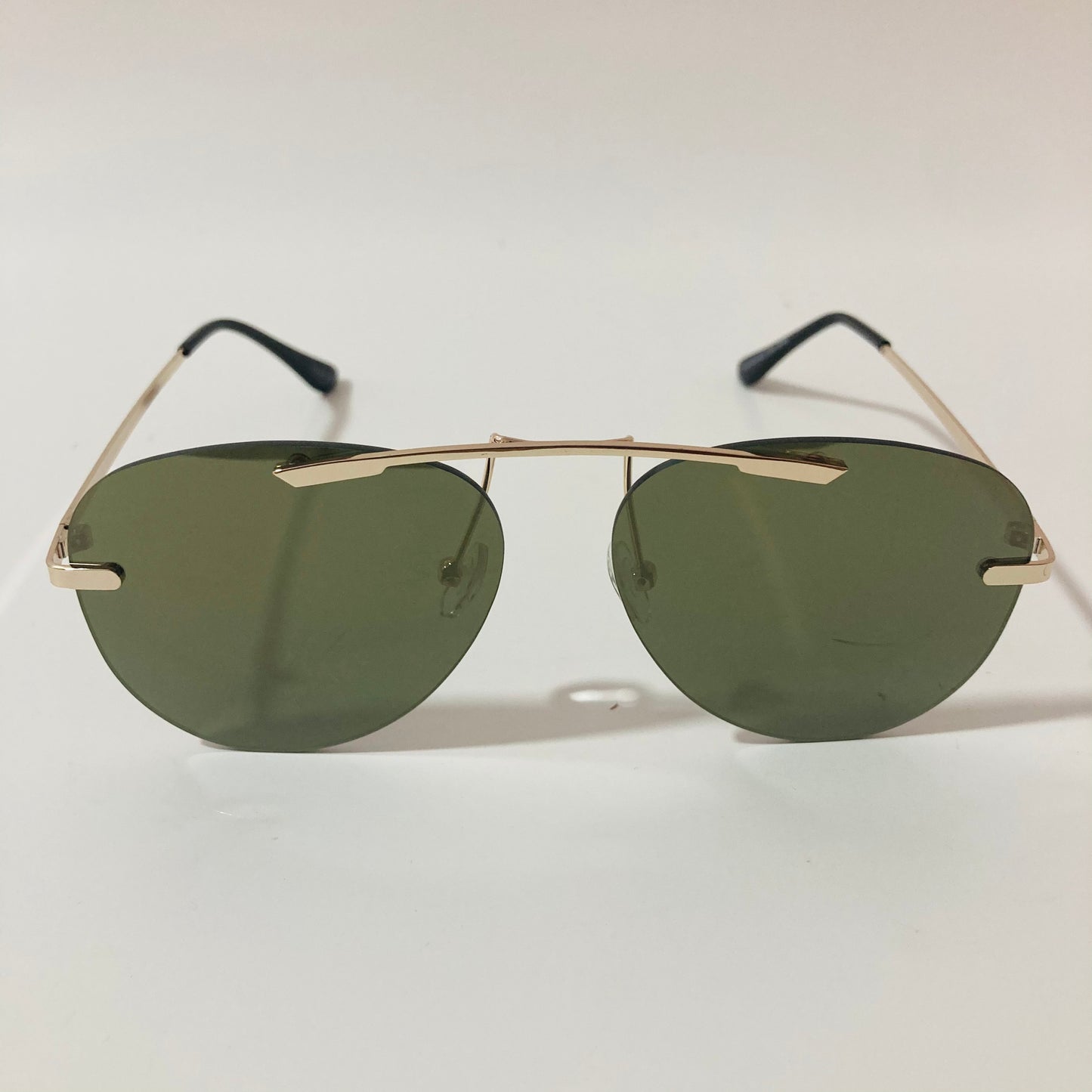 gold rimless aviator sunglasses with green mirror lenses