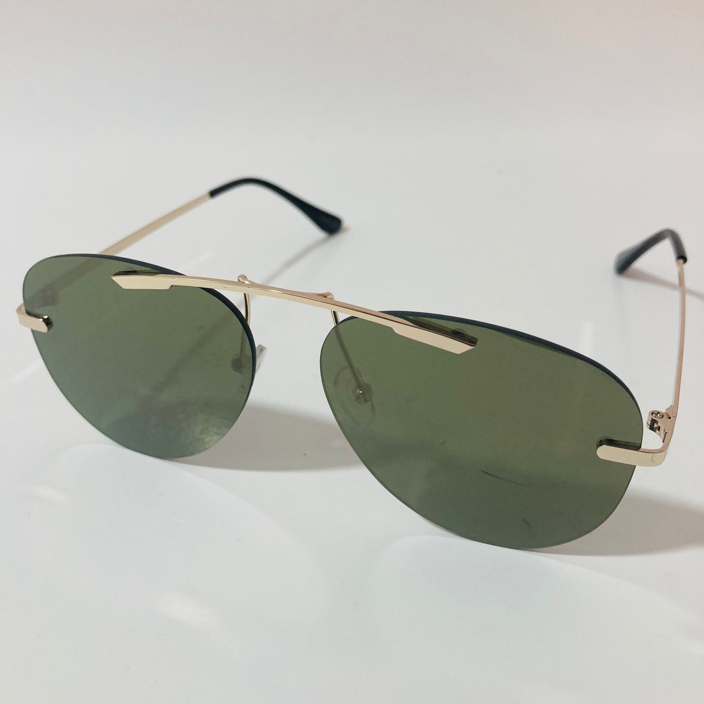 gold rimless aviator sunglasses with green mirror lenses