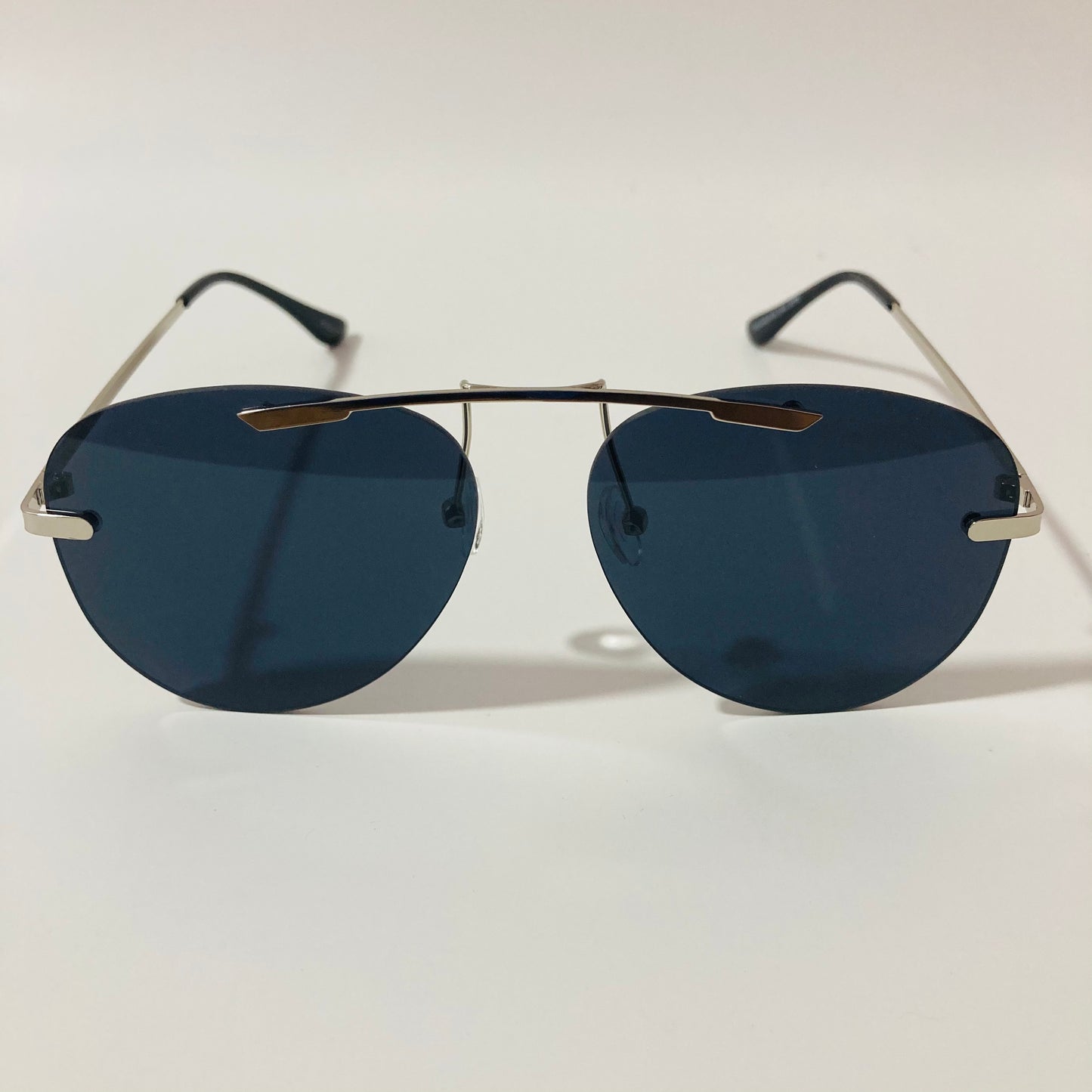 silver rimless aviator sunglasses with black mirror lenses