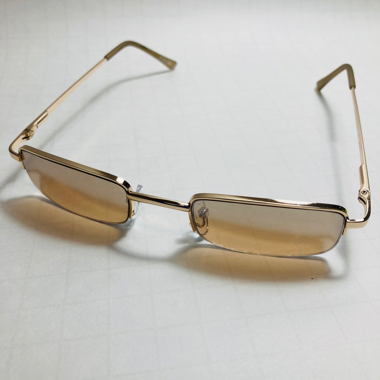 mens and womens brown and gold small square sunglasses
