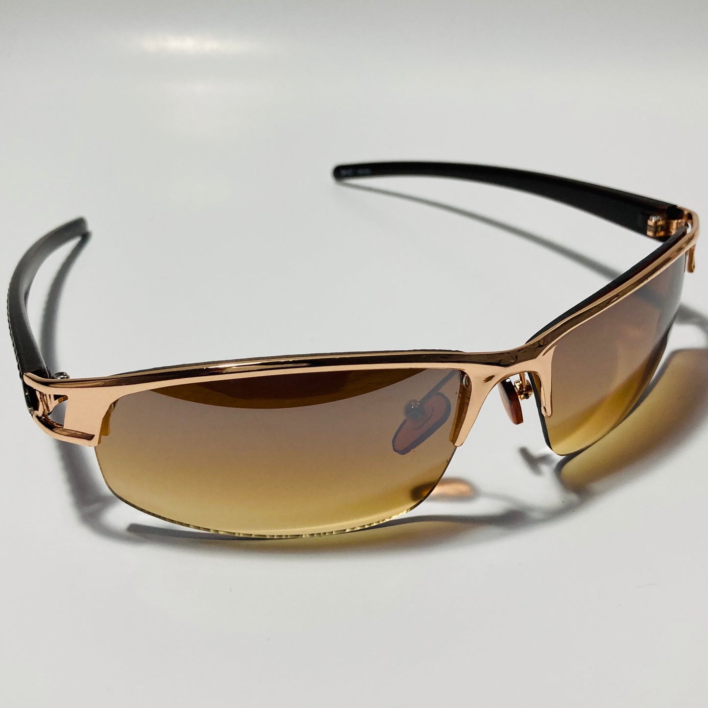 womens and mens gold wrap around sunglasses with brown lenses
