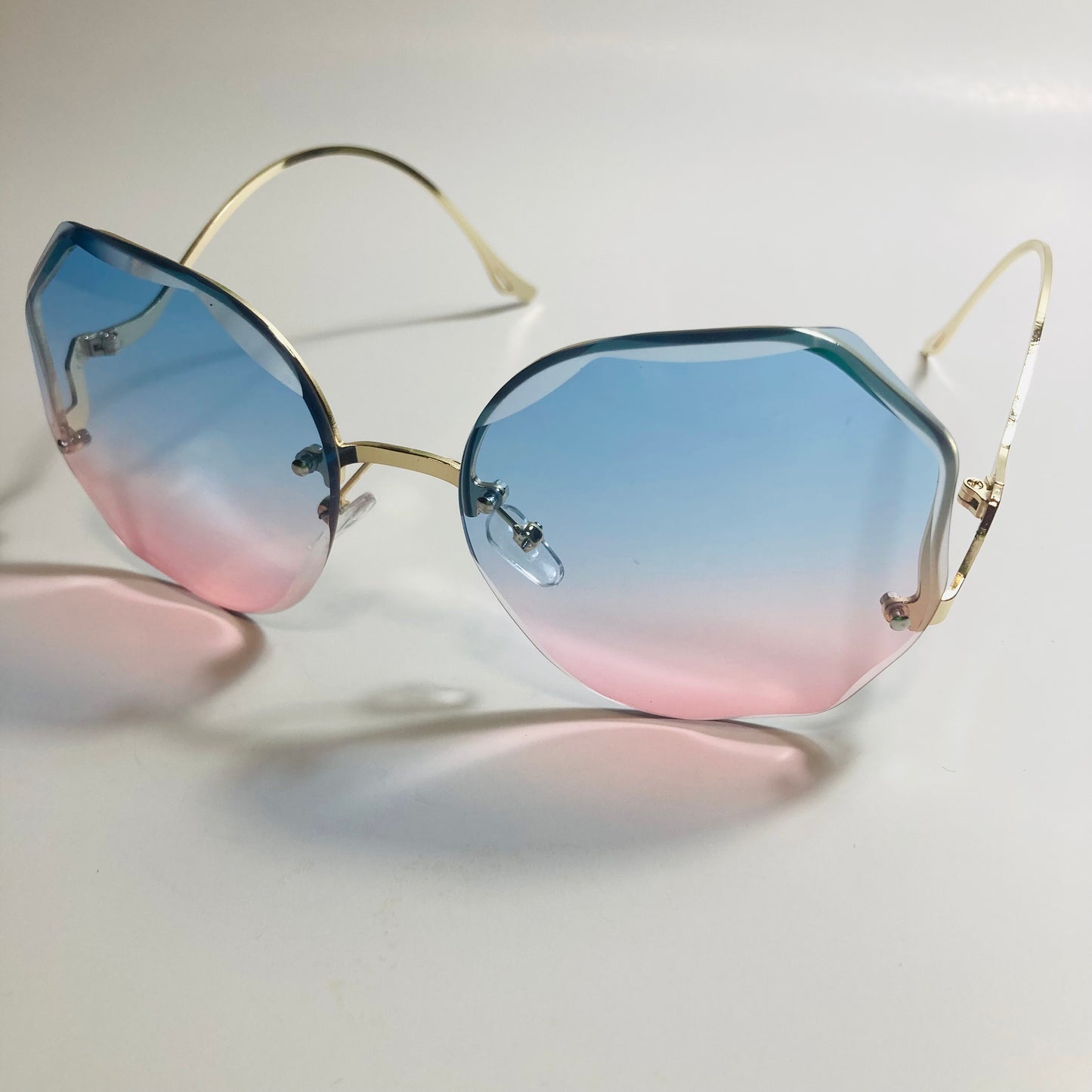 womens pink blue and gold rimless sunglasses