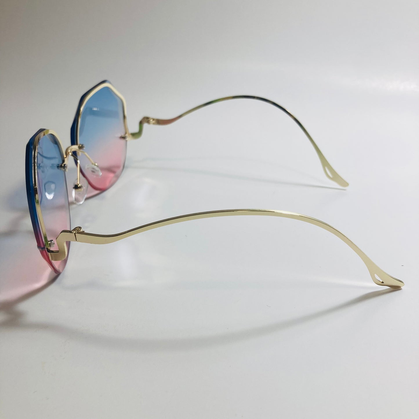 womens pink blue and gold rimless sunglasses