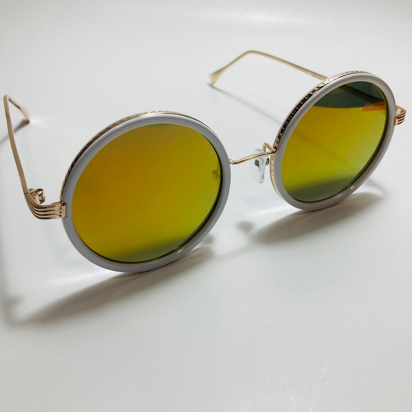 white and yellow womens round sunglasses with mirror lenses