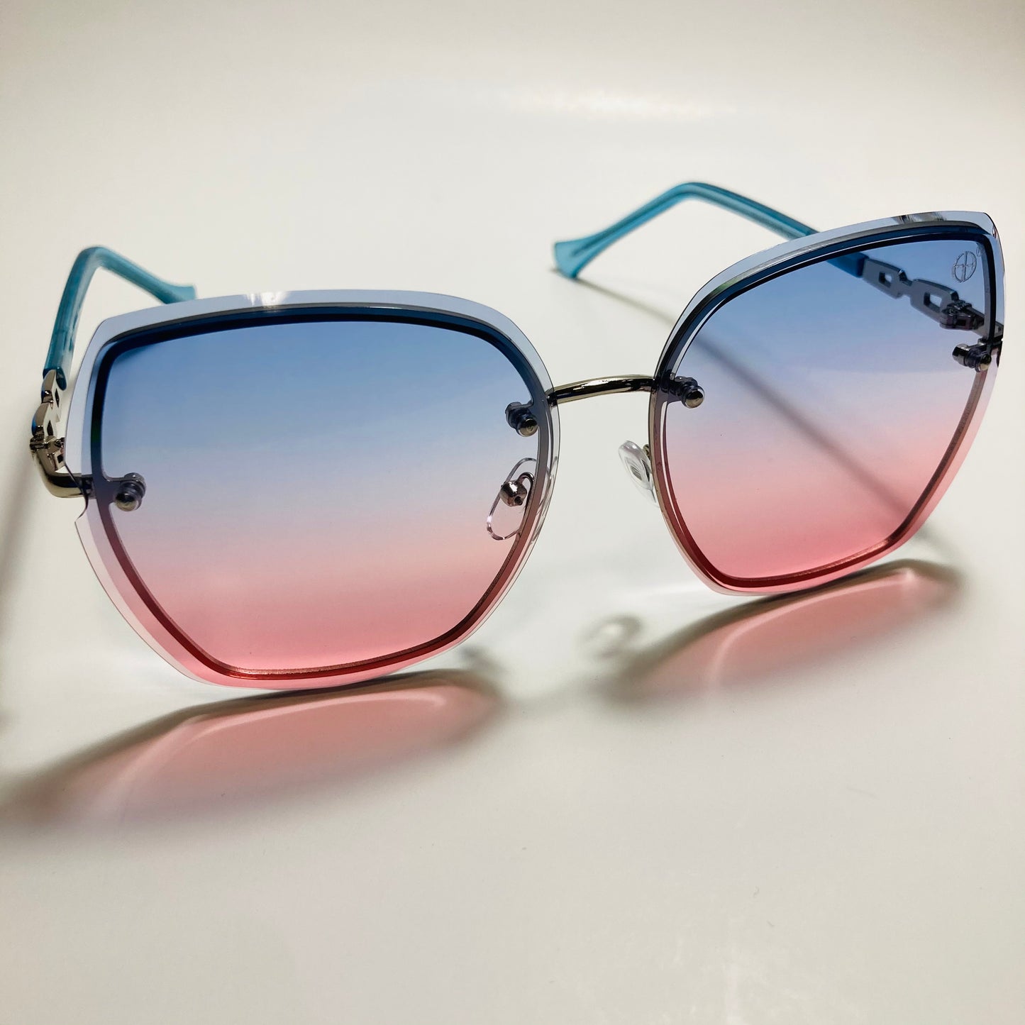 womens blue and pink rimless oversize sunglasses