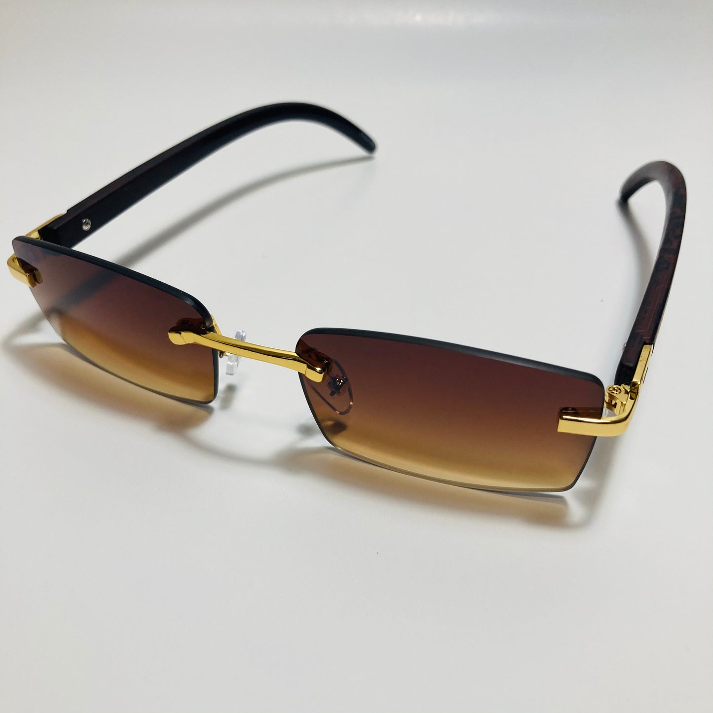 mens and womens brown and gold rimless square sunglasses