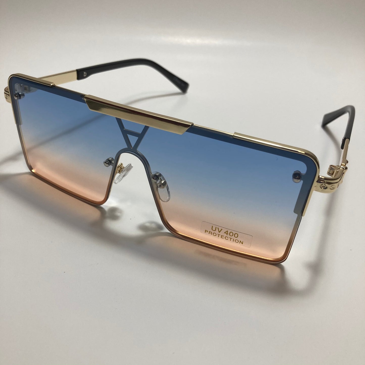 womens gold square oversize sunglasses with pink and blue lenses