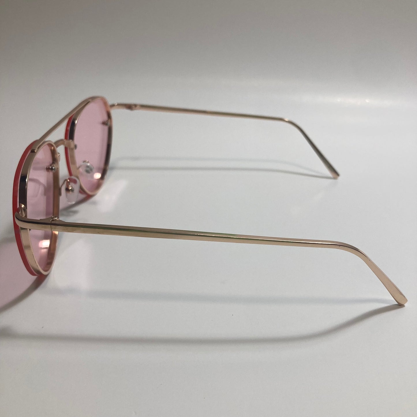 Womens and Mens gold Aviator sunglasses with pink lenses