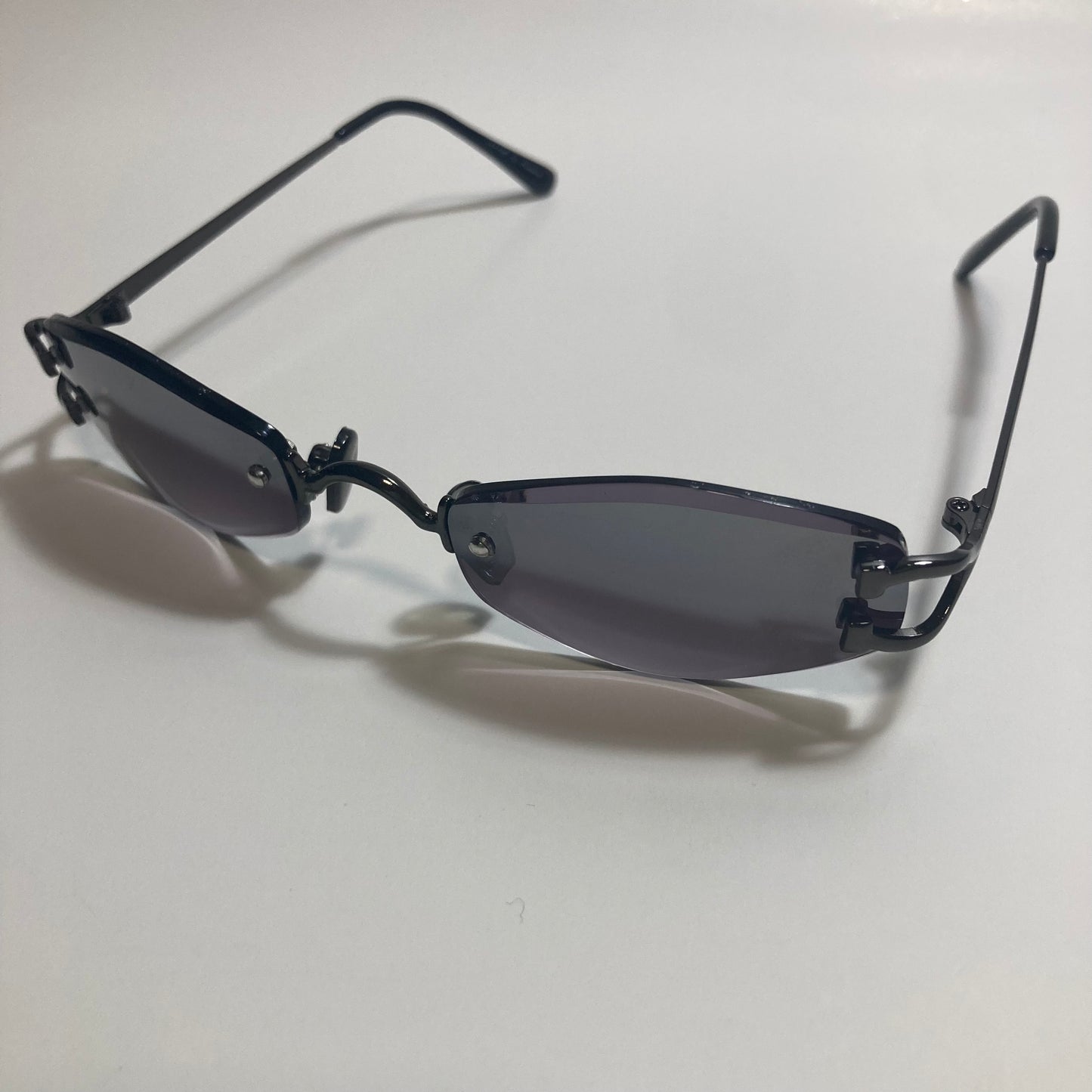 mens and womens black small rimless sunglasses