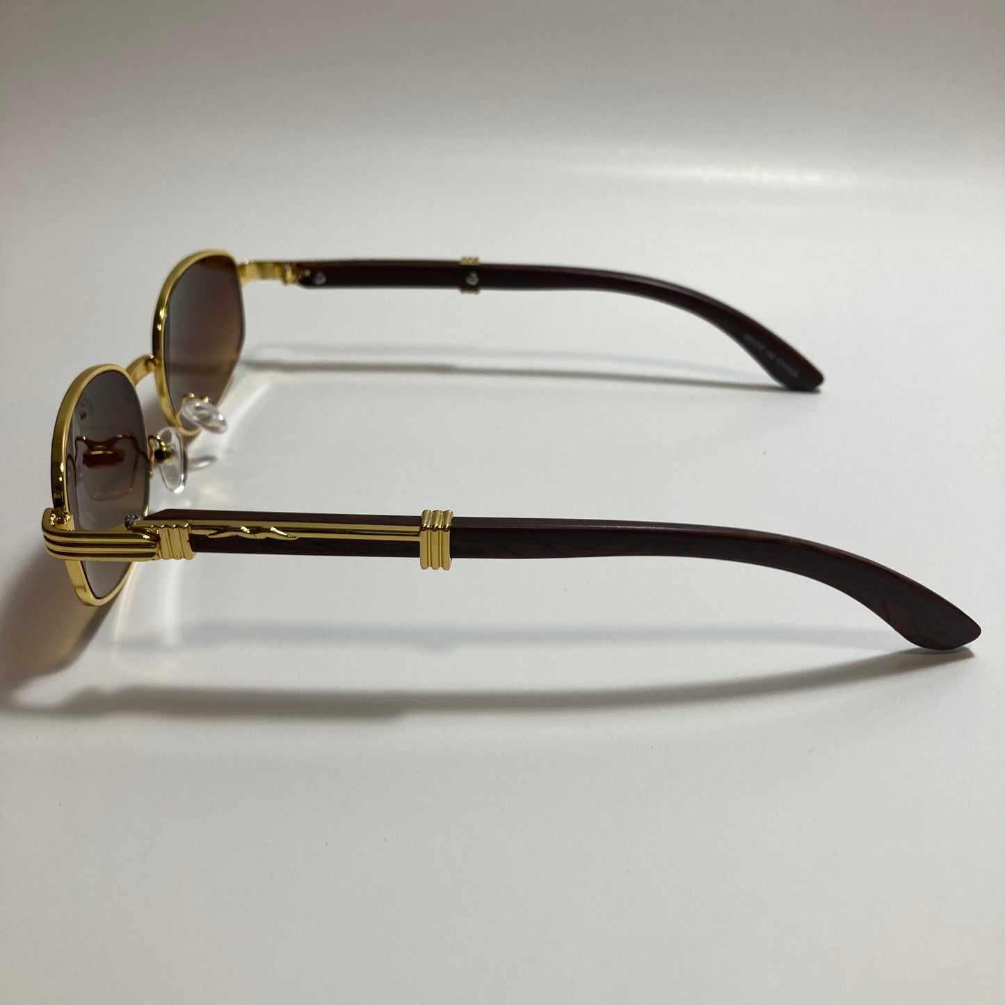 mens and womens brown and gold oval sunglasses