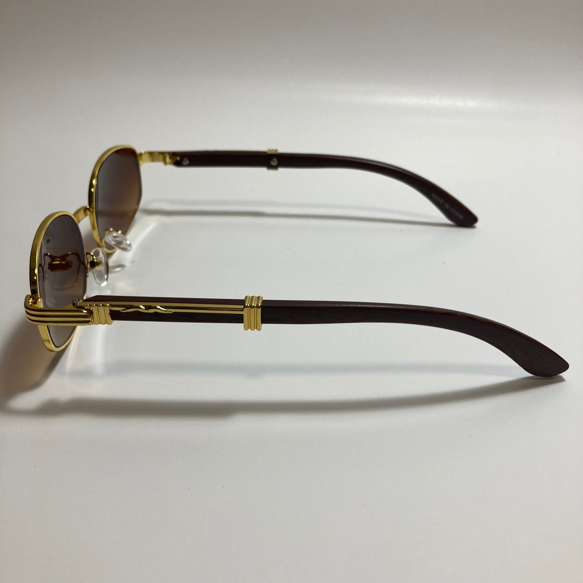 mens and womens brown and gold oval sunglasses