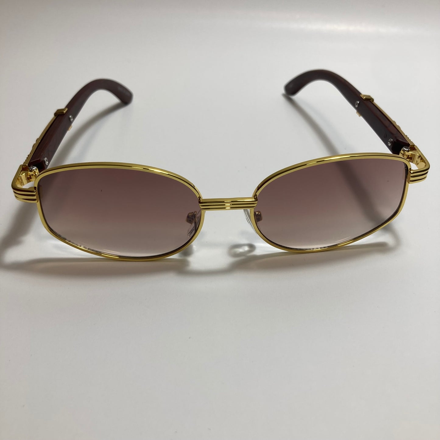 mens and womens brown and gold oval sunglasses