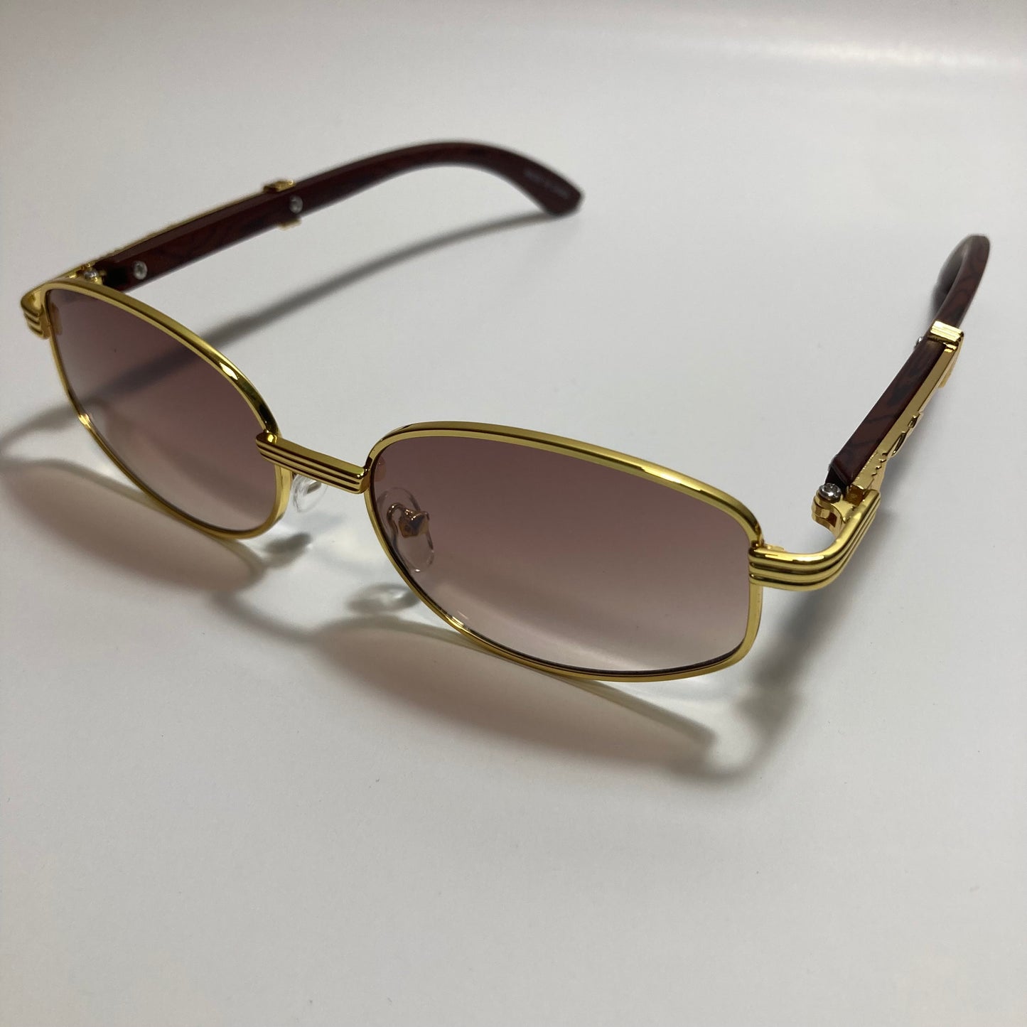 mens and womens brown and gold oval sunglasses