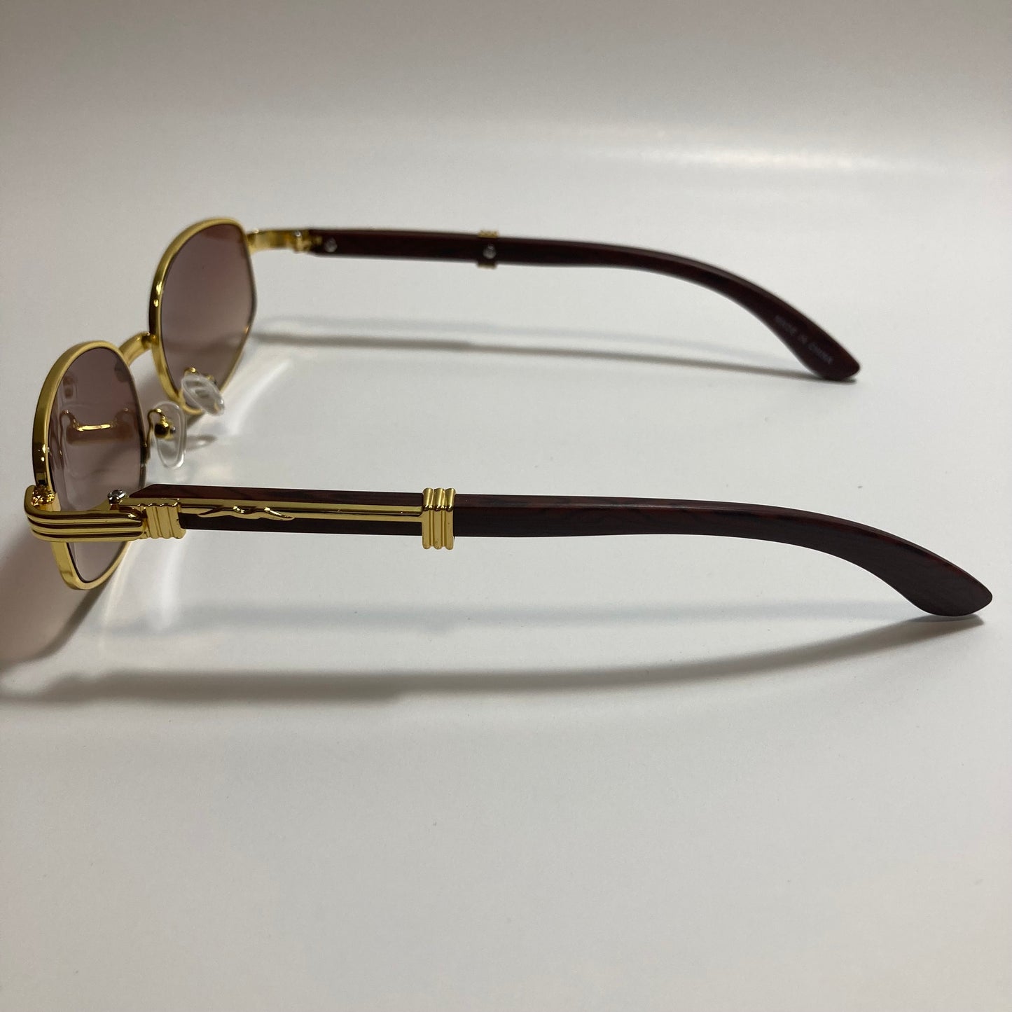mens and womens brown and gold oval sunglasses