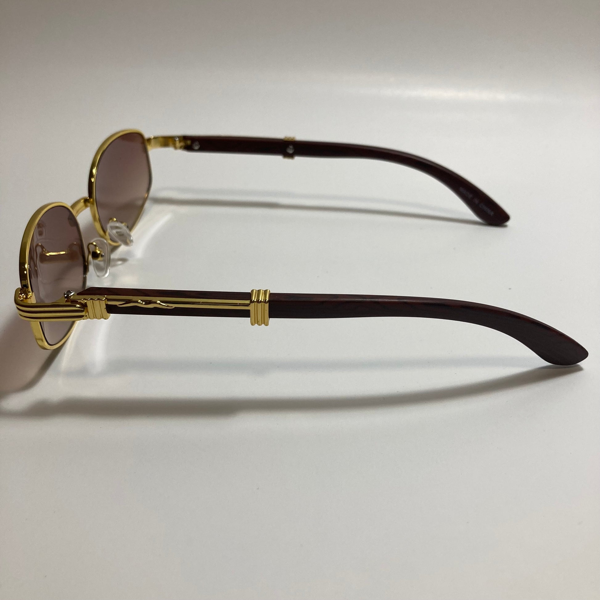 mens and womens brown and gold oval sunglasses