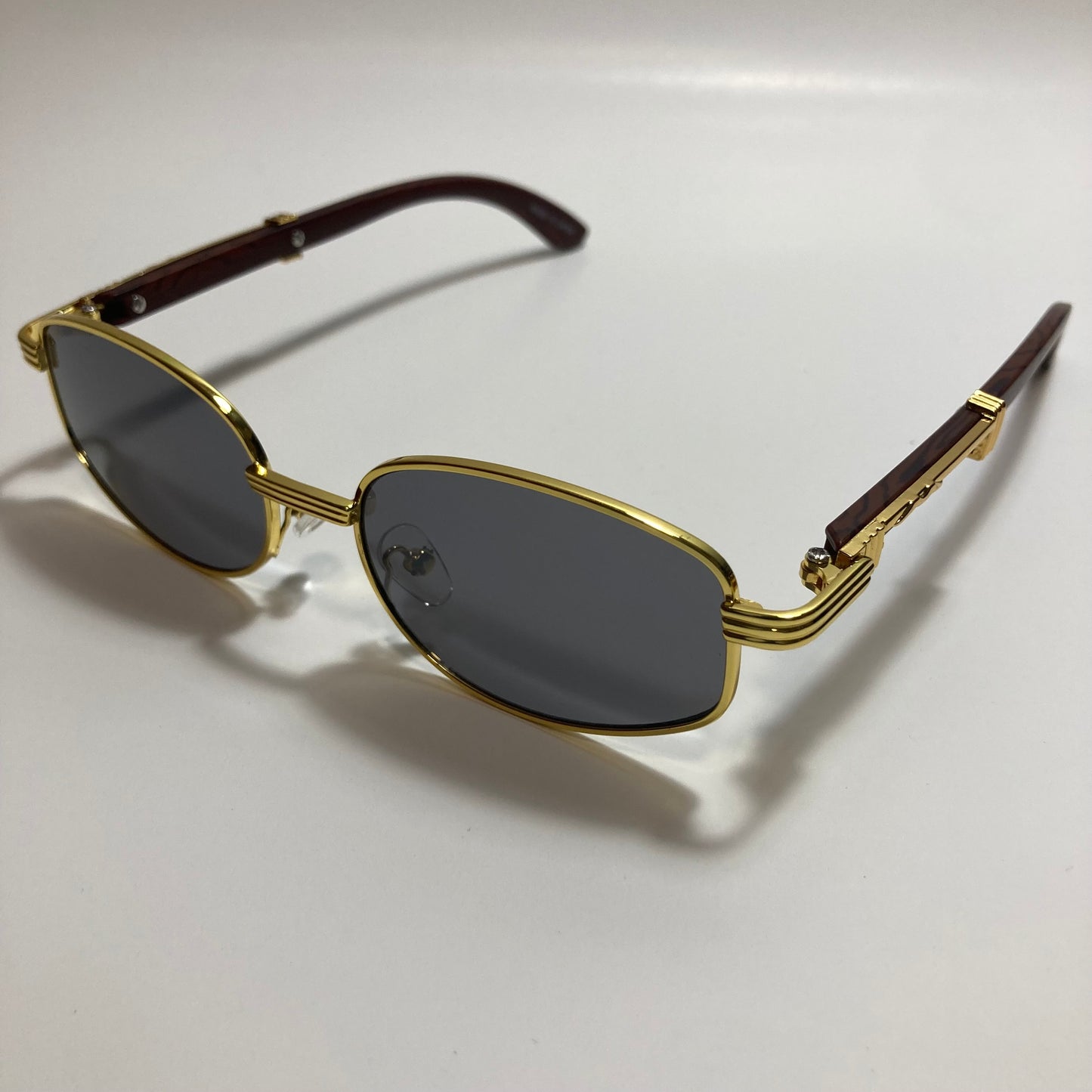 mens and womens black and gold oval sunglasses