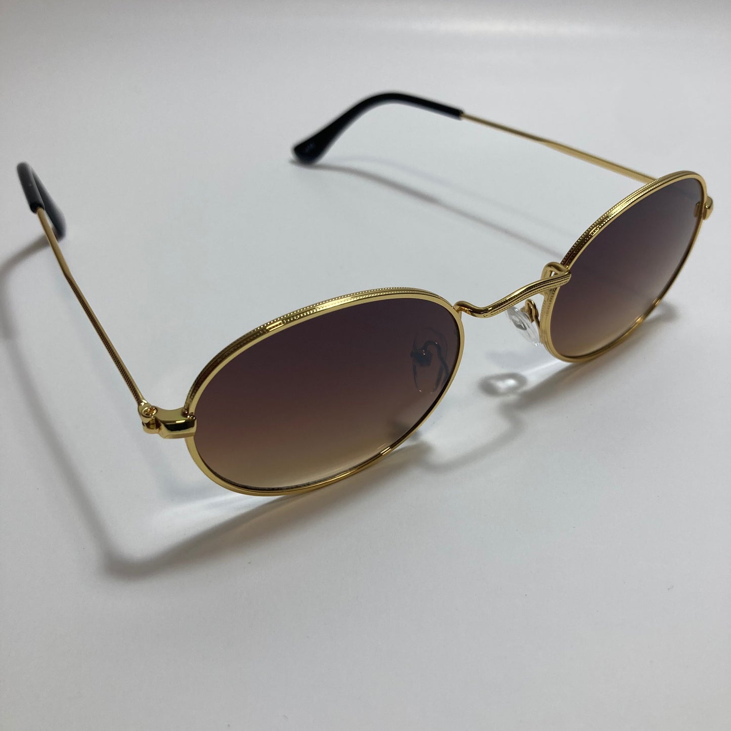 mens and womens small gold round sunglasses with brown lenses