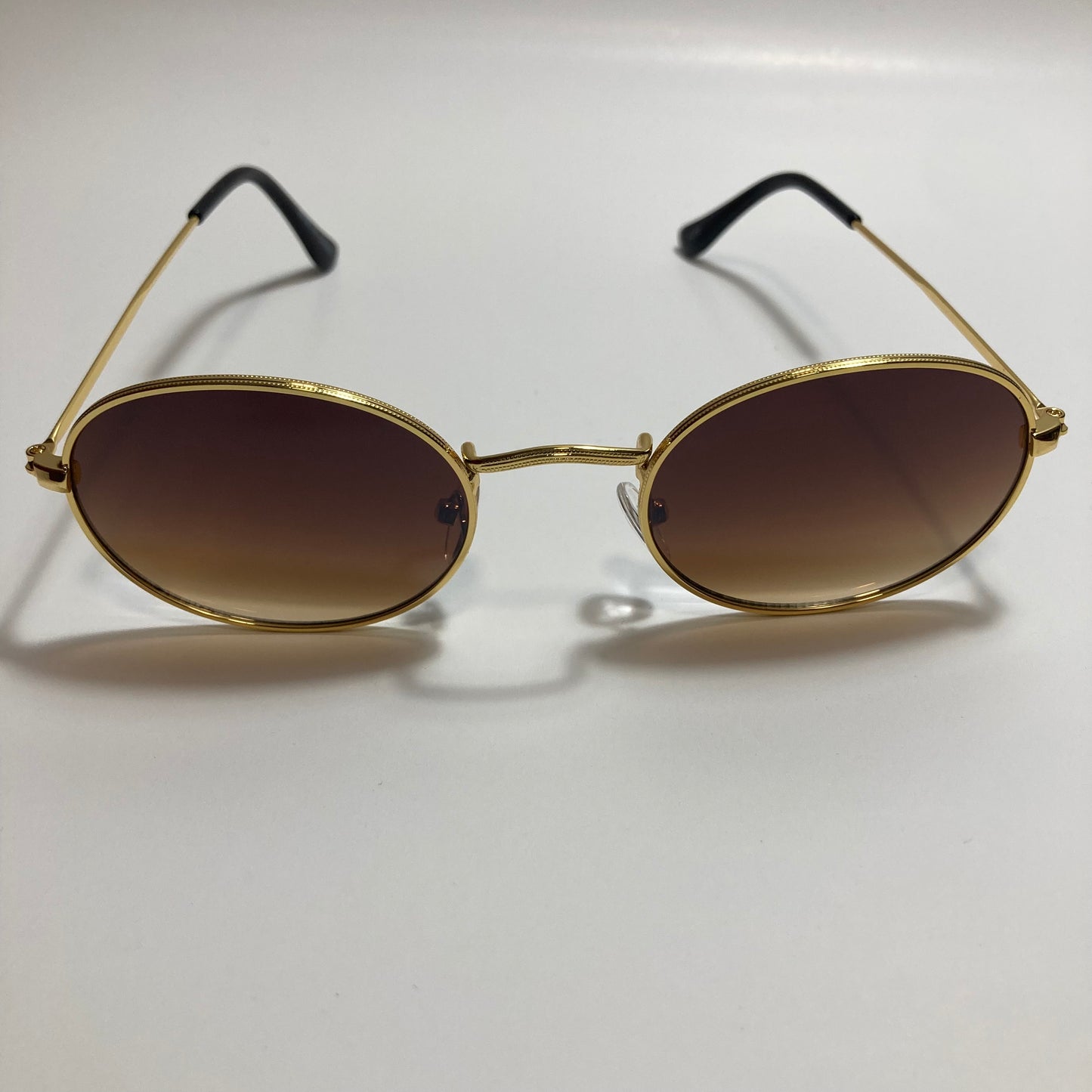 mens and womens small gold round sunglasses with brown lenses