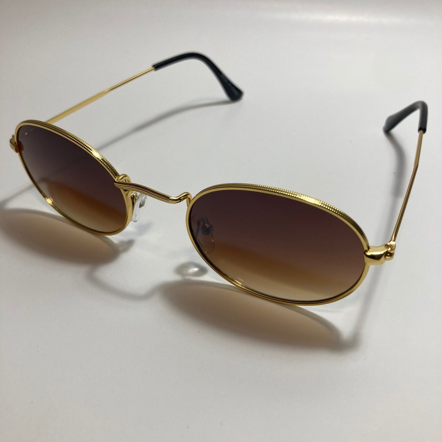 mens and womens small gold round sunglasses with brown lenses