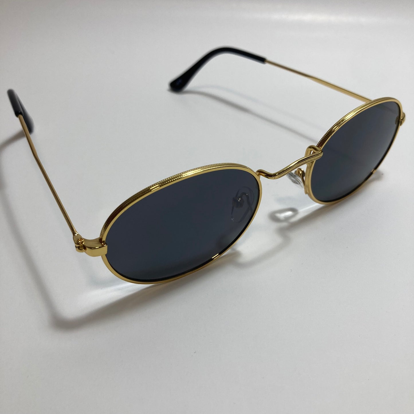mens and womens small gold round sunglasses with black lenses
