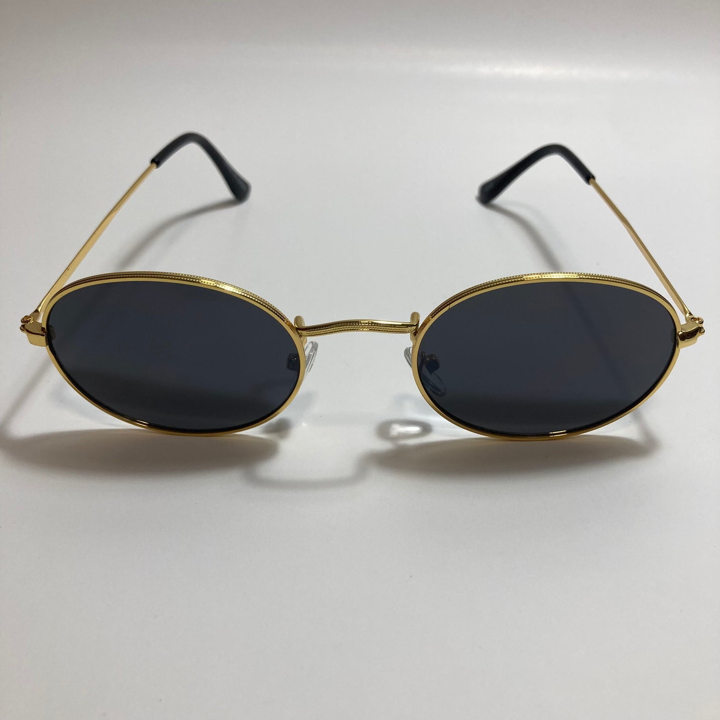 mens and womens small gold round sunglasses with black lenses