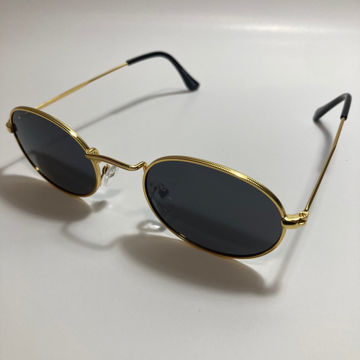 mens and womens small gold round sunglasses with black lenses