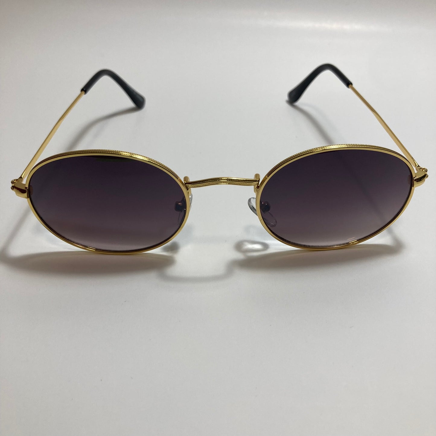 mens and womens small gold round sunglasses with black lenses