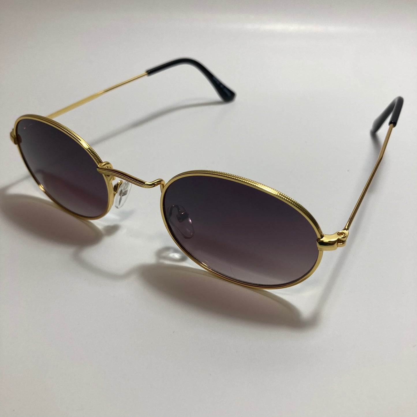 mens and womens small gold round sunglasses with black lenses