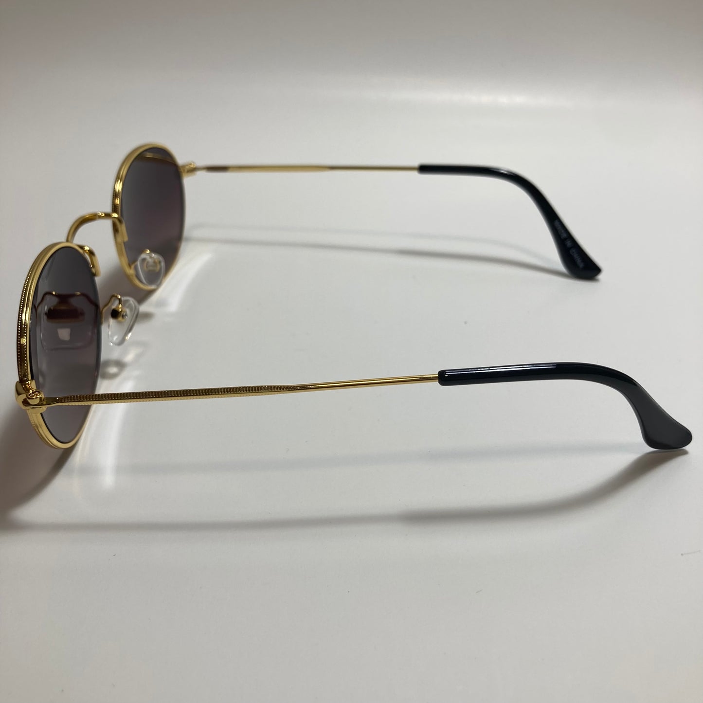 mens and womens small gold round sunglasses with black lenses