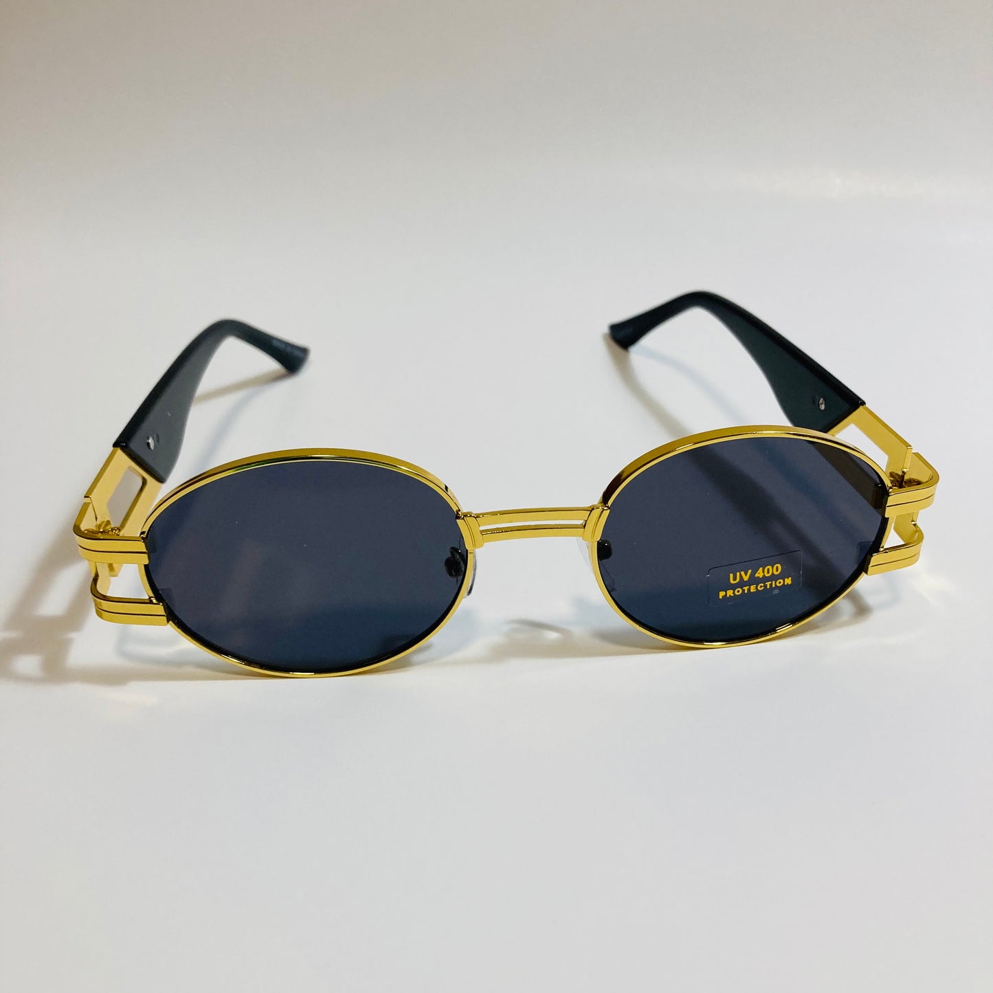 mens and womens gold and black round sunglasses